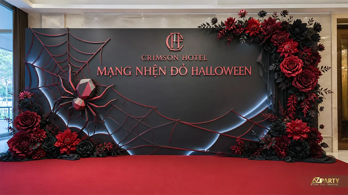 Khu chụp ảnh Halloween với mạng nhện đỏ, nhện khối và cụm hoa đen đỏ