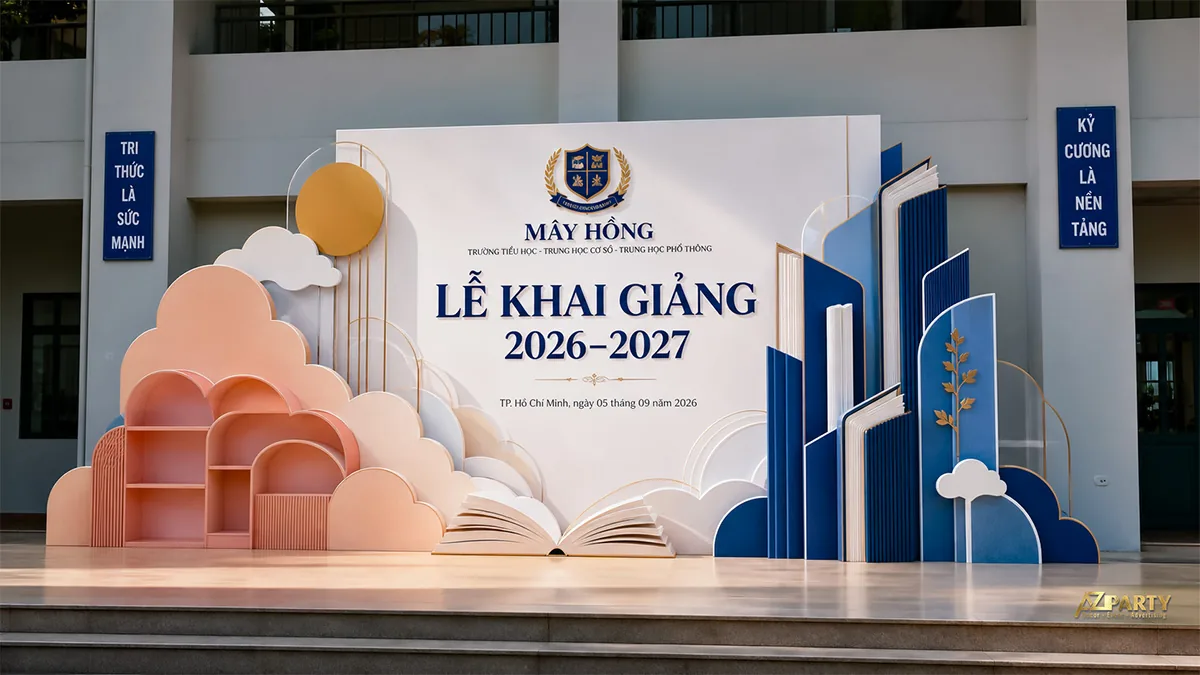 Backdrop lễ khai giảng trường Mây Hồng với mây pastel, kệ trang trí và sách mở