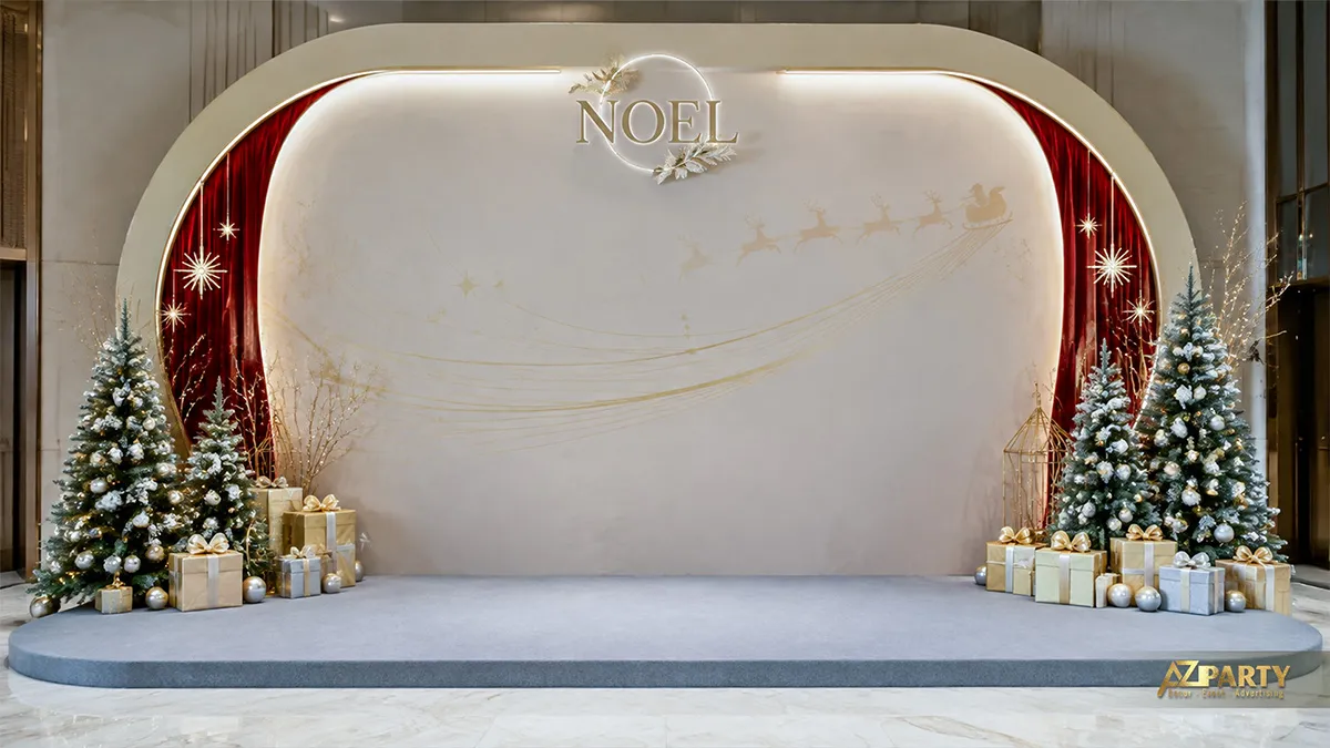 Backdrop Noel khung bo tròn màu kem vàng với chữ Noel, đường xe trượt tuyết và hai cây thông