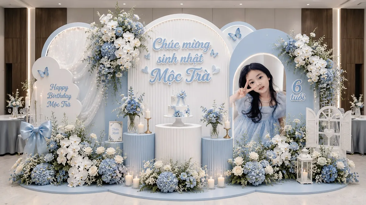 Sân khấu sinh nhật Mộc Trà 6 tuổi xanh trắng với hoa lan, cẩm tú cầu và ánh nến