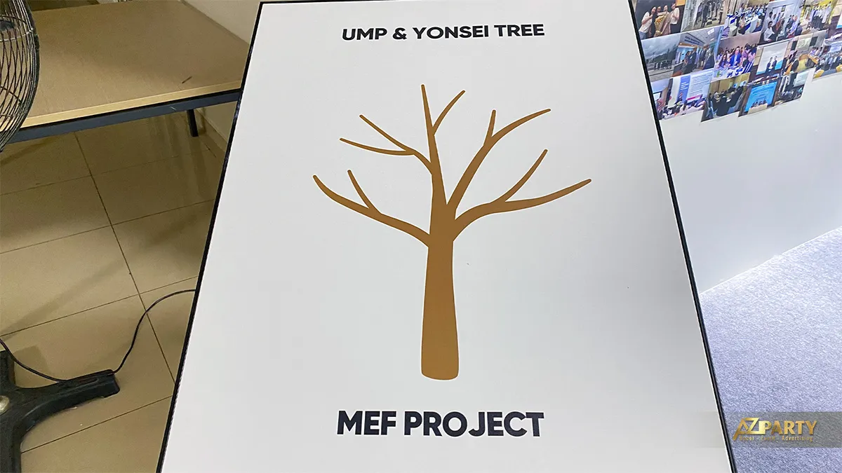 Bảng UMP and Yonsei Tree với hình cây màu vàng trên giá đứng ở lối vào