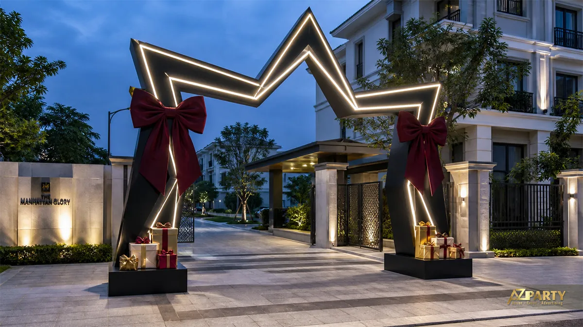 Cổng Noel ngoài trời dạng ngôi sao đèn viền, nơ burgundy và quà tặng hai bên