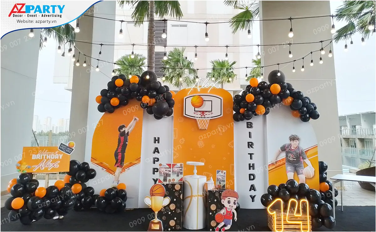 Trang trí tiệc sinh nhật ngoài trời chủ đề bóng rổ cho bé Alex tròn 14 tuổi với backdrop in hình bé chơi bóng, rổ ném bóng, chữ số 14 gắn đèn LED nổi bật kết hợp bóng bay màu đen và cam.