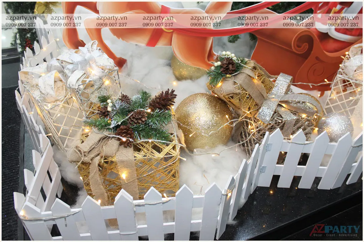 Các hộp quà trang trí Noel độc đáo làm bằng khung thép bọc sợi thô mộc mạc đặt trên nền bông tuyết giả trắng xóa.