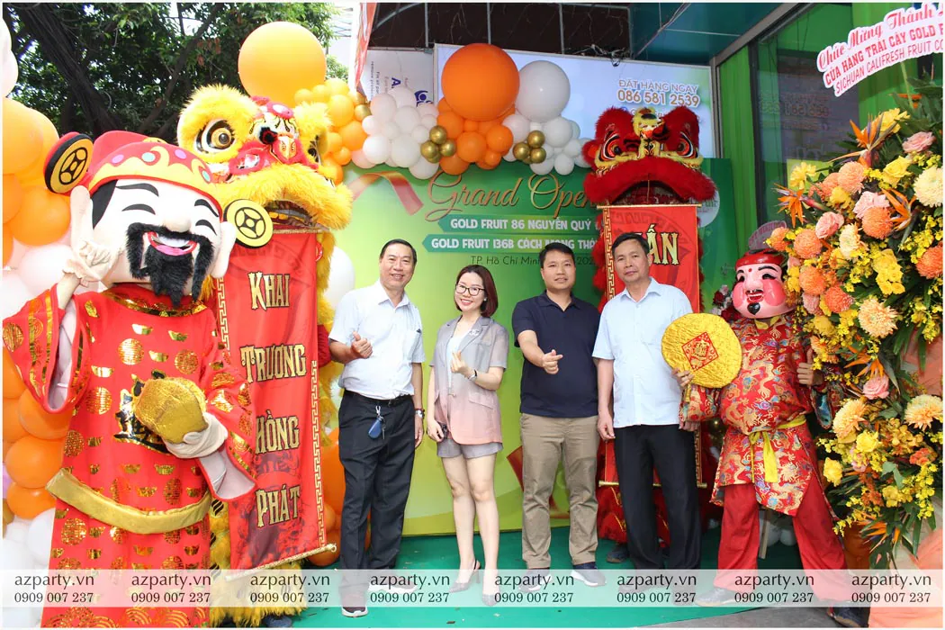 Khách mời chụp ảnh kỷ niệm trước backdrop khai trương cửa hàng trái cây Gold Fruit Sài Gòn