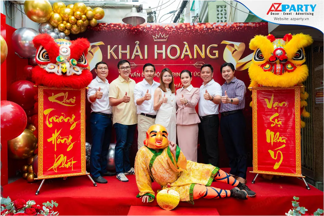 Khách mời chụp hình kỷ niệm cùng Ông Địa trên sân khấu khai trương văn phòng Khải Hoàng.