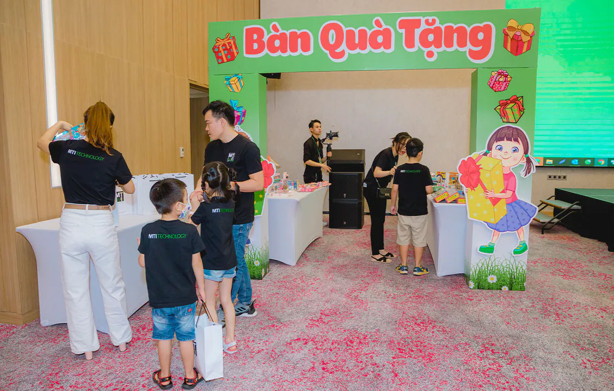 Khu vực Bàn Quà Tặng được trang trí sinh động, nơi nhân sự ban tổ chức phát quà và trao niềm vui cho các gia đình nhân viên MTI Technology.