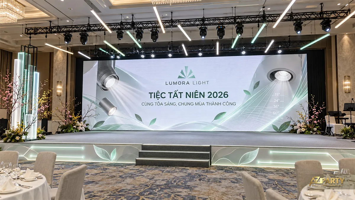 Sân khấu trắng xanh ngọc có hình đèn rọi và thanh sáng treo
