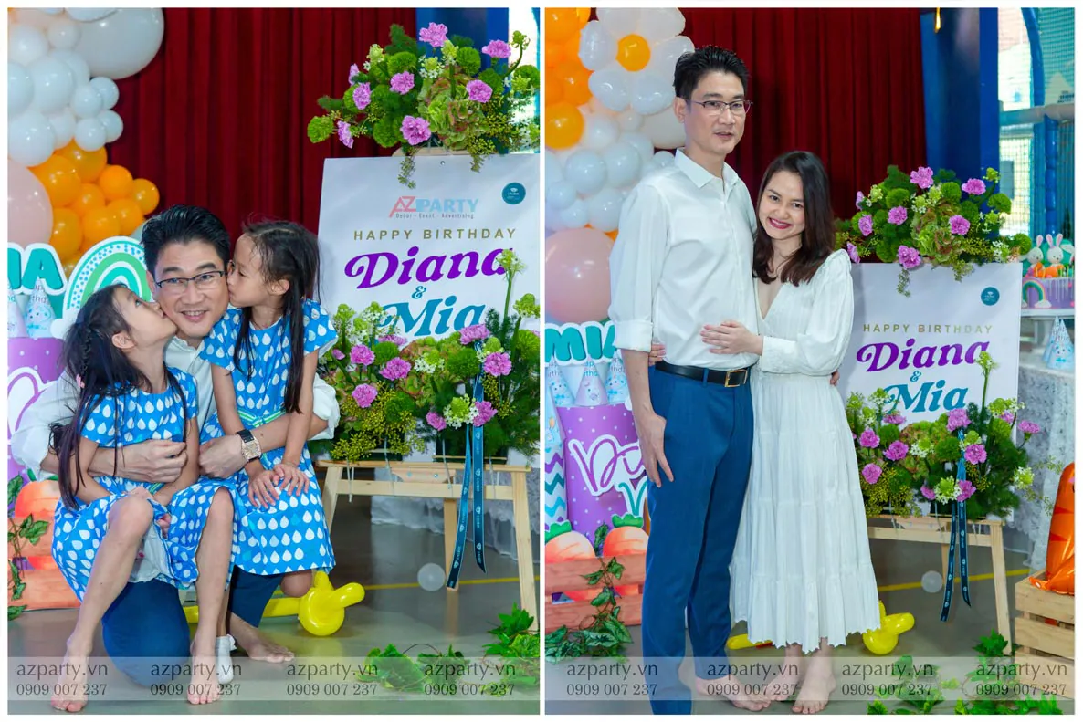 Hình ảnh gia đình hạnh phúc chụp ảnh kỷ niệm ấm áp bên bảng chào mừng sinh nhật Diana & Mia.