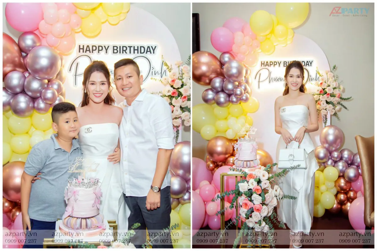 Chủ nhân bữa tiệc Phương Đình cùng gia đình rạng rỡ chụp hình kỷ niệm bên chiếc bánh kem 3 tầng trang trí macaron và vương miện tại không gian tiệc sinh nhật ngọt ngào.