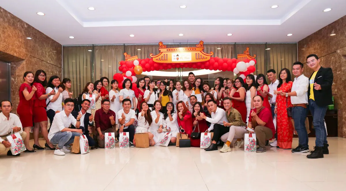 Tập thể nhân viên Trung tâm Tiếng Trung Ni Hao chụp hình kỷ niệm tại cổng chào tiệc tất niên phong cách Á Đông