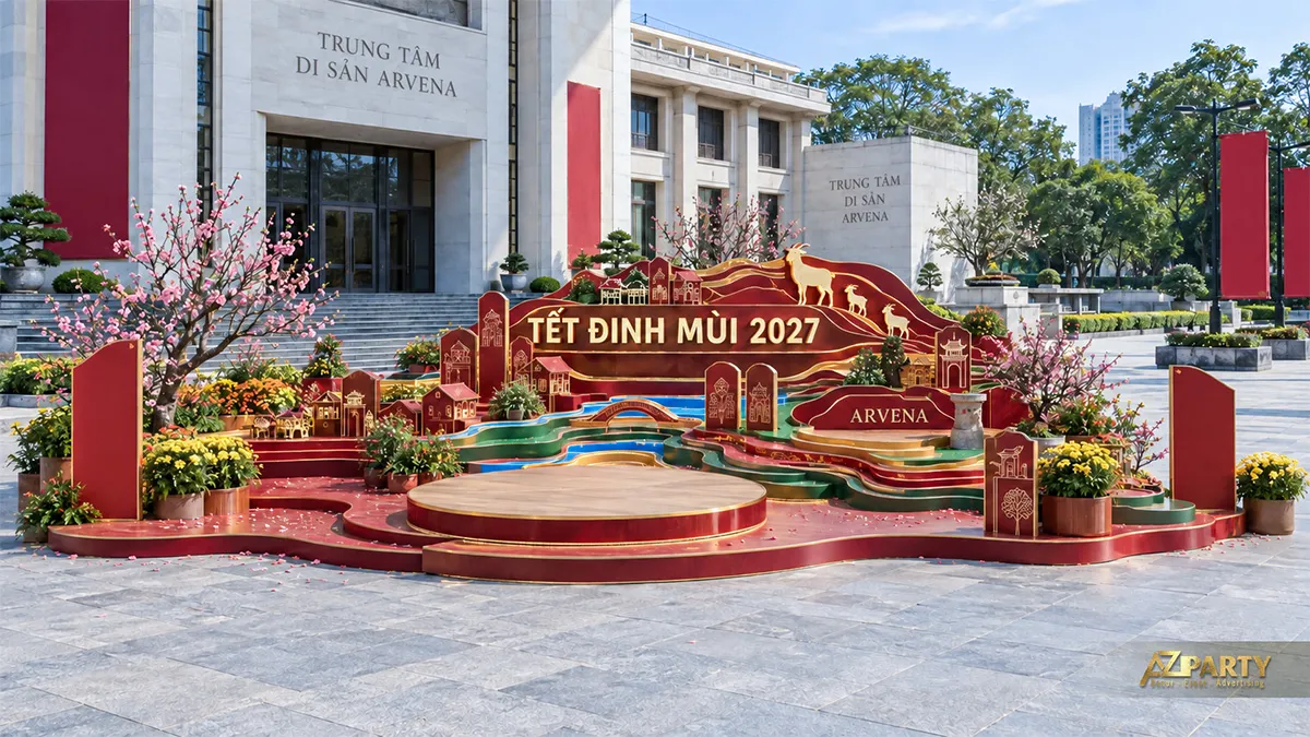 Sân khấu Xuân trước công trình văn hóa với hình dê, mái nhà và cây hoa