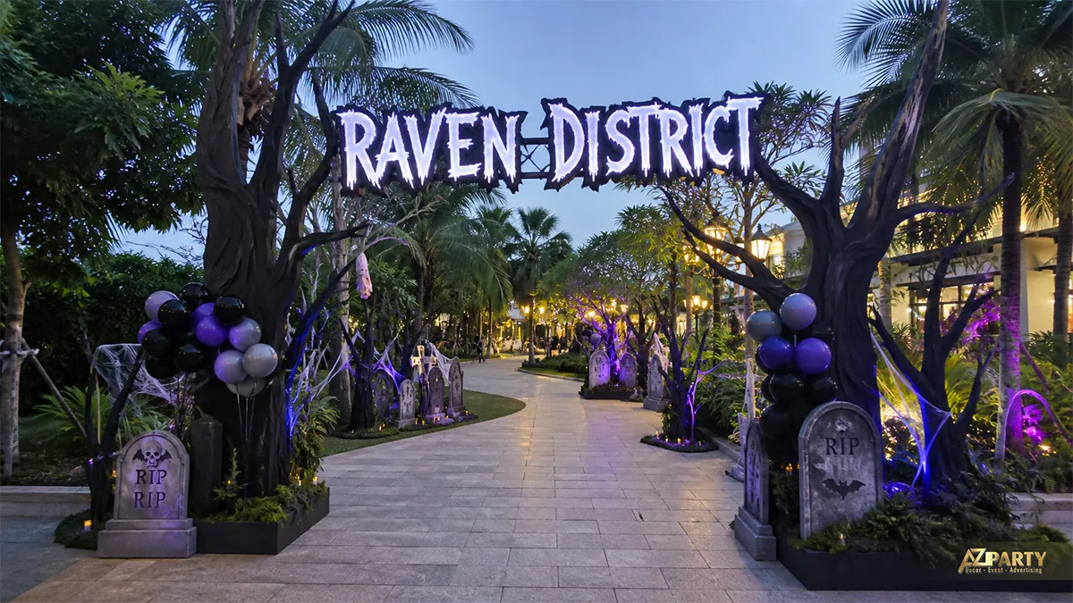 Lối vào Raven District phủ cây tối màu, bia mộ và ánh sáng tím dọc đường dẫn