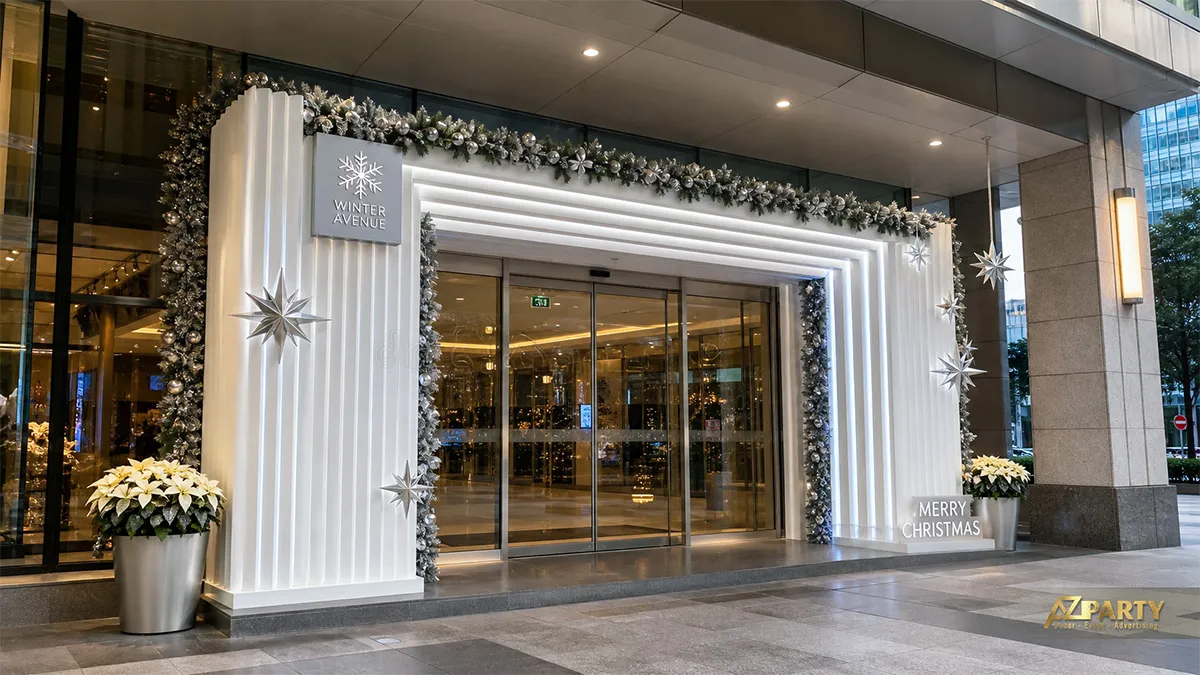 Lối vào Winter Avenue với khung gân trắng, vòng lá bạc và chữ Merry Christmas