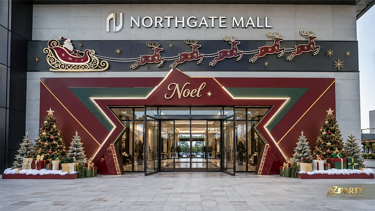 Cổng vào trung tâm thương mại với khung Noel đỏ rượu, xe trượt tuyết, cây thông và hộp quà
