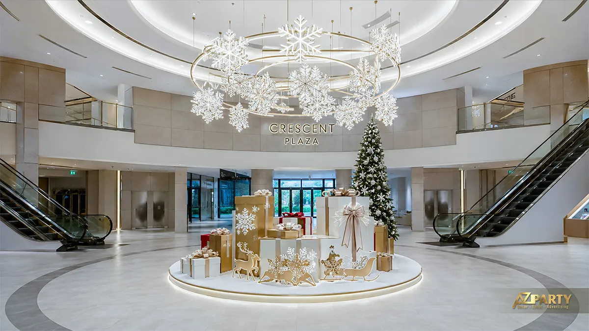 Tiểu cảnh Noel trắng bạc đặt giữa sảnh với cây thông, hộp quà, đèn ngôi sao và mô hình tuyết