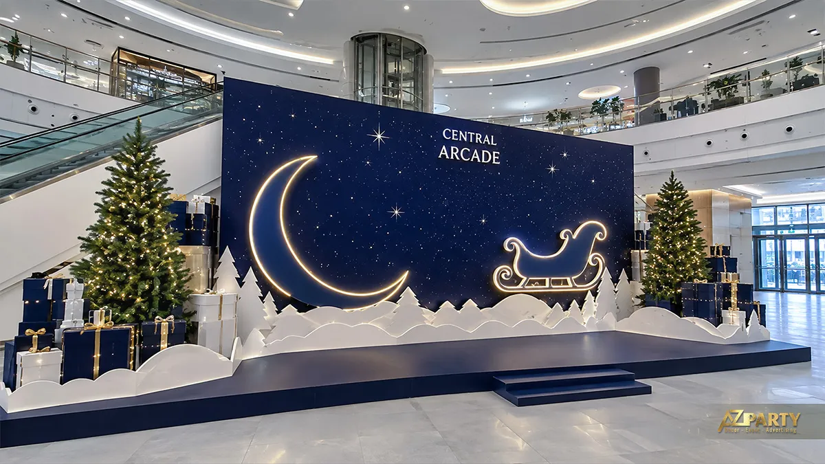 Backdrop Noel xanh navy đặt trong sảnh với trăng khuyết phát sáng, xe trượt tuyết và cây thông