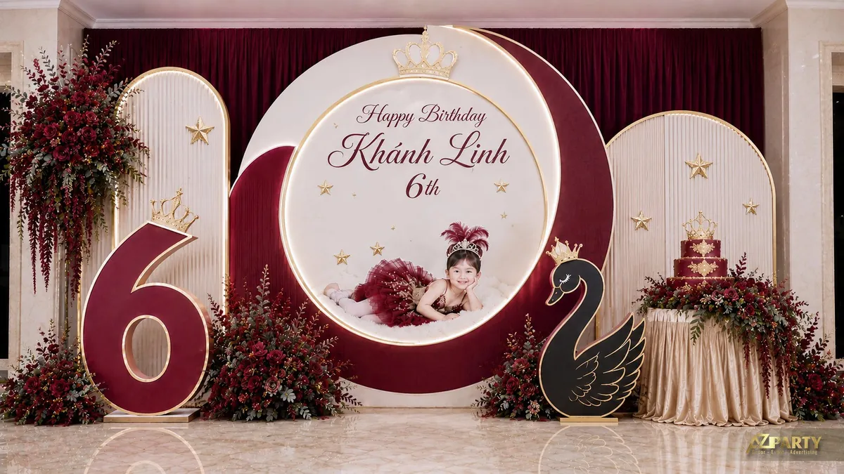 Trang trí sinh nhật bé gái tone đỏ rượu sang trọng với backdrop tròn, hoa đỏ và thiên nga đen