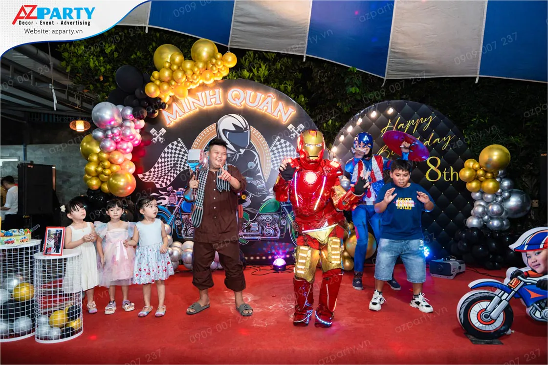 Nghệ sĩ hóa trang thành siêu anh hùng Iron Man (Người Sắt) và Captain America (Đội trưởng Mỹ) đang biểu diễn và giao lưu với các bé trên sân khấu tiệc sinh nhật bé Minh Quân.