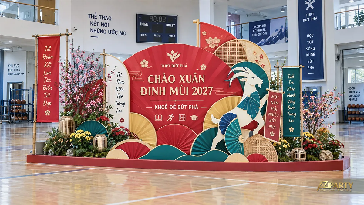 Backdrop nhà thi đấu với linh vật dê vận động cùng quạt giấy