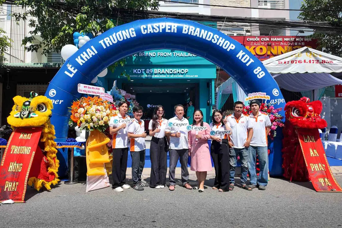 2 Sếp nam và nữ cùng nhân viên chụp hình tại cổng hơi của buổi lễ khai trương