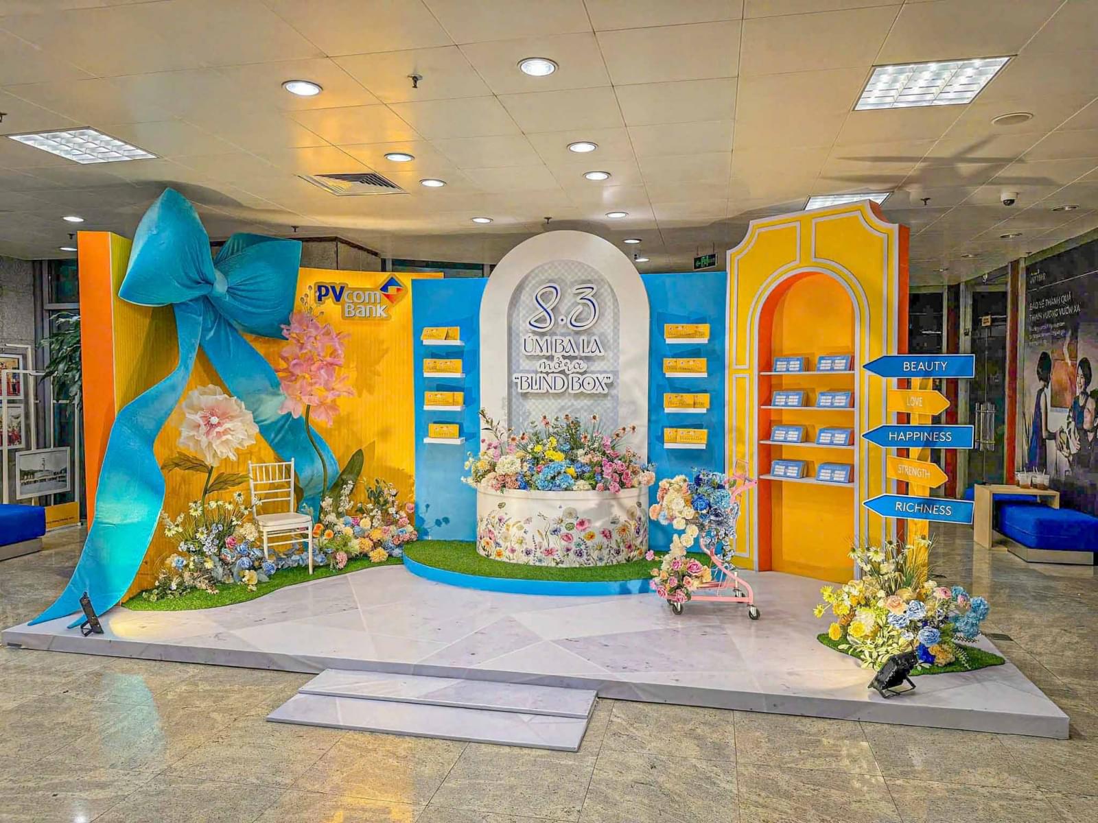 Trang trí backdrop 8/3 tại văn phòng với mô hình nơ lớn, vườn hoa thơ mộng 