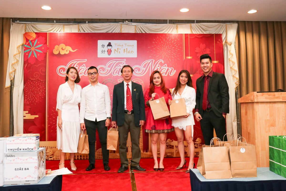 nhân viên chụp hình kỷ niệm sau khi nhận quà tặng trên sân khấu